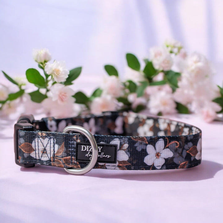 Floral-patterned dog collar with 'Dizzy Dog Collars' brand on a light background with flowers.