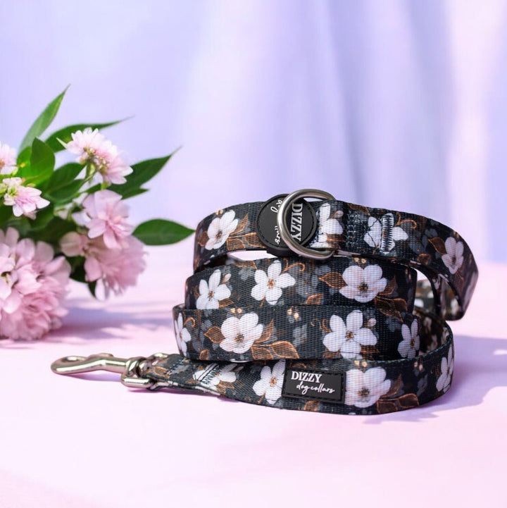 Floral-patterned dog collar and leash with flowers in the background