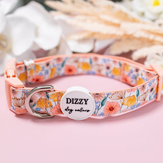 Floral patterned dog collar with a personalized tag on a pink background