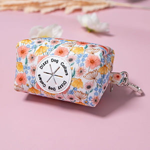 Floral-patterned pouch with a keychain on a pink background